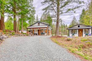a cottage in the woods with a driveway at Private Ranch 2BR Cabin Retreat Sleeps 9 in Anacortes