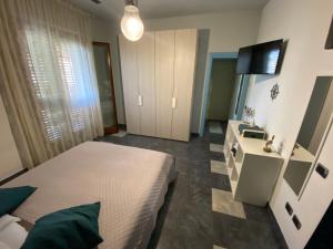 a bedroom with a bed and a television in it at La dimora del marinero in San Benedetto del Tronto