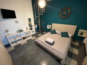 a bedroom with a bed with a wheel on the wall at La dimora del marinero in San Benedetto del Tronto