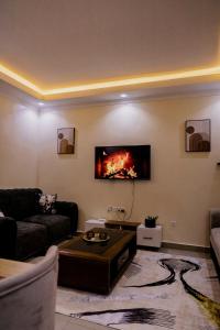 a living room with a fire on the wall at Peaceful Nest Apartment in Kigali
