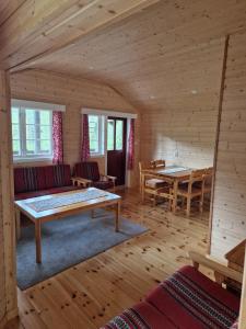 a living room with a couch and a table at Hov Hyttegrend in Viksdalen