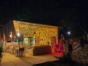 a building with a yellow curtain on it at night at Erdem Ciftligi/ Ephesus Arena in Selçuk