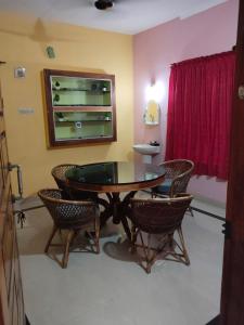 a dining room with a table and chairs at AS Villa Homestay in Varkala