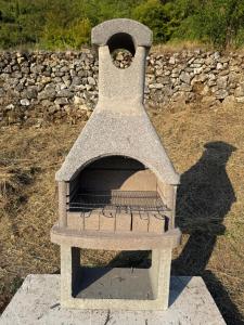 a stone oven with a bird inside of it at ORAHOVSTICA TRAIL - Glamping in Dupilo