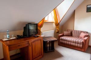 a living room with a tv and a couch at Kolyba House in Kyiv