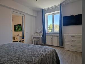a bedroom with a bed and a large window at Central Mangalia in Mangalia