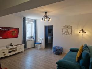 a living room with a couch and a tv at Ultracentral Mangalia seaside deluxe apartament in Mangalia