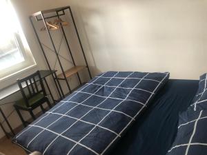 a bedroom with a bed and a chair and a window at Urban Stay & Style in Parsberg