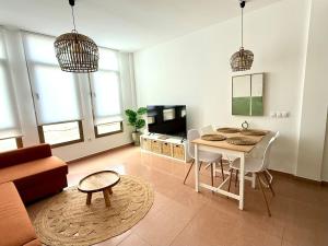 a kitchen and living room with a table and chairs at WAY R ST Sweet home in Gran Tarajal