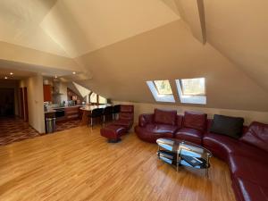 a living room with a couch and a table at Maximo - 50m from the Beach in Darlowko