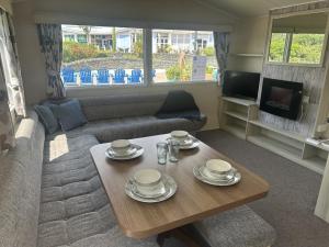 a living room with a coffee table and a couch at Ty - Bach in Chwilog