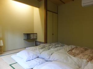 Voodi või voodid majutusasutuse Guesthouse Mikkaichi toas