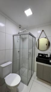 a bathroom with a shower and a toilet and a mirror at Casa com 2 Quartos Climatizados e Garagem in Juazeiro +9 photos