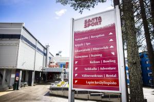 a sign for a santa sport in front of a building at Studio Ski Lodge in Rovaniemi