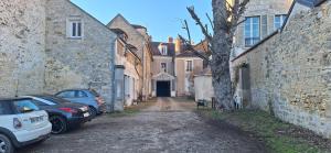 an alley with cars parked in front of buildings at Studio du BoisDHyver in Fontainebleau