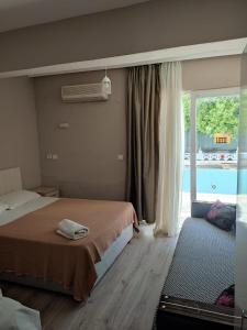 a bedroom with two beds and a window with a pool at Garden Prizma Apart in Kemer