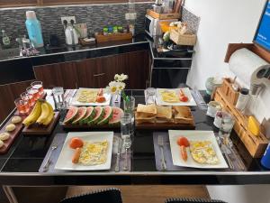 a buffet with plates of food on a table at Mount Elegance in Nuwara Eliya +52 photos