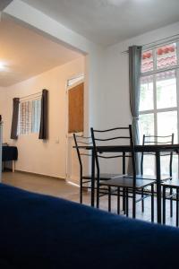 a room with chairs and a table and a window at Apartment near downtown in Guanajuato
