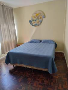 En eller flere senge i et værelse på Apartamento Guarapari