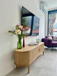 a vase of flowers on a wooden table in a living room at Villa Vincek in Mostar +22 photos
