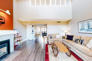 a living room with a couch and a fireplace at Wintergreen 223 in Blue Mountains