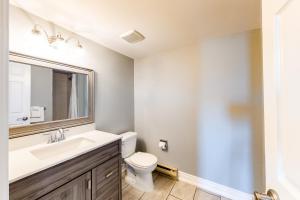 a bathroom with a sink and a toilet and a mirror at Wintergreen 223 in Blue Mountains +22 photos