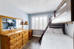 a bedroom with a bunk bed and a mirror at Wintergreen 223 in Blue Mountains