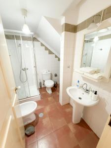a bathroom with a sink and a shower and a toilet at Casa das Ancoras Historic Beach Guesthouse in Buarcos Portugal in Bicas