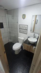 a bathroom with a toilet and a sink at BOHÍO del Pescador Barquero - Diverso y con Alma in Medellín
