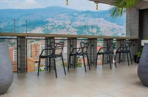 a group of black chairs sitting on top of a roof at BOHÍO del Pescador Barquero - Diverso y con Alma in Medellín