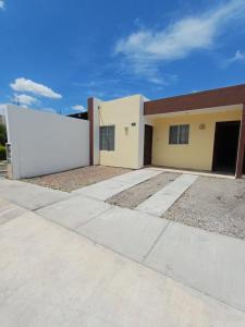a building with a large white sign in front of it at Casa Sendero in Los Mochis