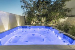 a blue hot tub sitting on the side of a building at Saitis Luxury Residence - 15 min from Matala - Kommos - Kalamaki Beach in Tympáki