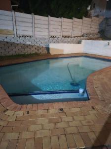 a swimming pool with a golf ball in it at Charming Cottage for Getaways in Empangeni +5 photos