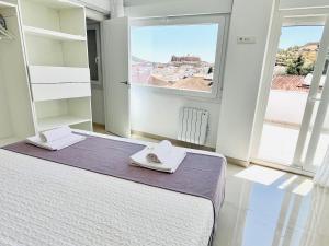 Katil atau katil-katil dalam bilik di Apartamentos Principado de Aracena