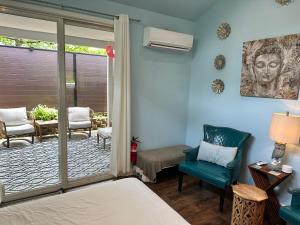 a room with a bed and chairs and a patio at Yoga Castia Complimentary Canoeing in Hot Springs