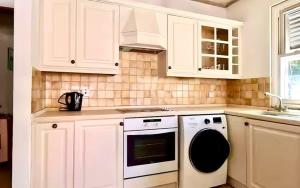 a kitchen with white cabinets and a dishwasher at ZenBreak Kings Beach #12 in Saint Peter