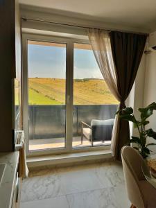 a room with a window with a view of a field at Olive&Air Haven in Cluj-Napoca +2 photos
