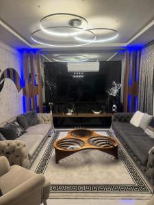 a living room with a couch and a large tv at Villa SONNE in Antalya
