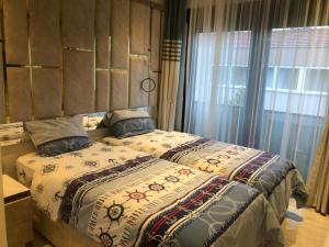 a bedroom with two beds and a large window at Villa SONNE in Antalya +51 photos