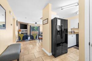 a kitchen with a black refrigerator in a room at Fairway View Escape - For 8 in Branson