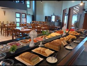 a buffet with many different types of bread and pastries at Flat 4-109 in Ilhabela
