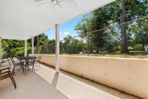 a patio with a table and chairs on a roof at Fairway View Escape - For 8 in Branson
