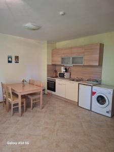 a kitchen with a table and a dining room at JULY MORNING SEAside HOTEL in Kavarna
