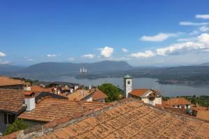 a town with a clock tower on top of roofs at La Casa nel Borgo Lake View - Happy Rentals in Nebbiuno