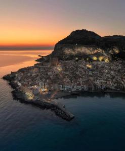 an aerial view of an island in the ocean at sunset at Apartment in Villa Sea Horizon Sand Beach in Cefalù +20 photos
