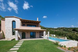 a villa with a swimming pool and a house at The sagehill-stonehouse in Mathía