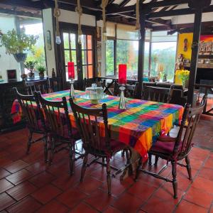 a table with a colorful table cloth on it at Finca Chiala in Subachoque