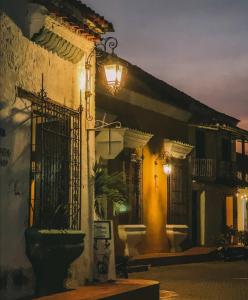 a building with a light on the side of it at El Marquez in Mompos