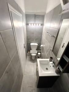 a small bathroom with a toilet and a sink at The Artist's Nook - Syntagma Escape in Athens