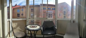 a view of a building from a window with a table and chairs at Guesthouse with 3 rooms in Oslo